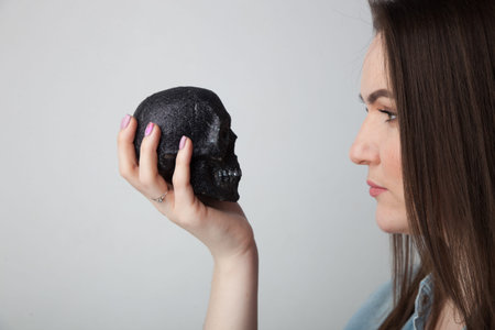 girl and a small black skullの写真素材