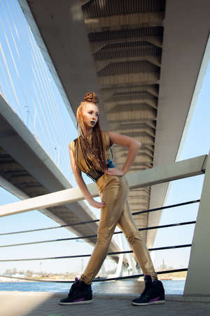 girl with dreads dancing under the bridgeの写真素材
