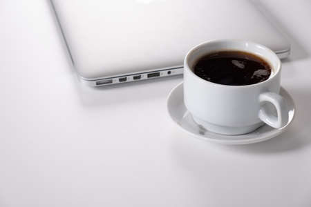 Laptop, notebook Tablet and cup of coffee on work deskの写真素材