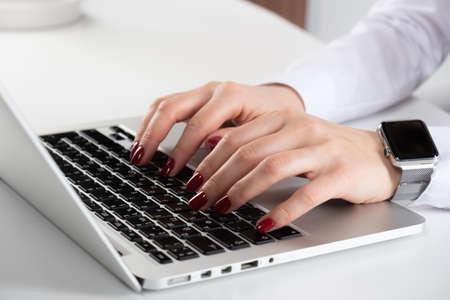 Woman's hand typing on computer keyboardの写真素材