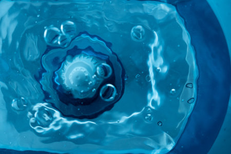 Top view of the water which is filtered through a filter in a blue decanter for water purificationの写真素材
