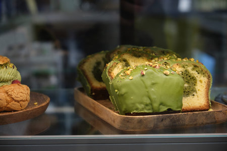 pistachio cupcake on the store counter close-up in a dark key