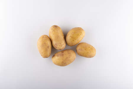 young white potatoes close-up on a white backgroundの写真素材