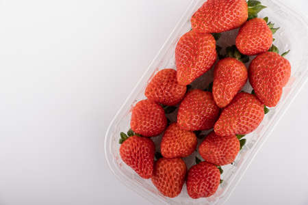 fresh strawberries in box isolated on whiteの写真素材