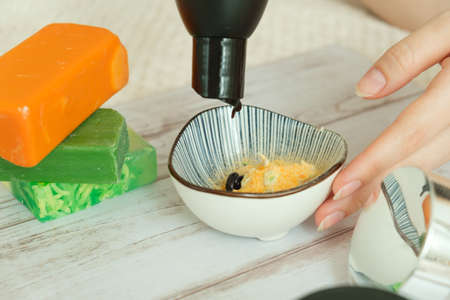 DIY cosmetics. hands in the frame create a cream of different ingredients.の写真素材