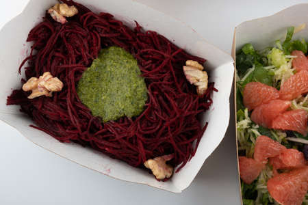 a set of different salads for vegetarians and raw foodists ready to eat in cardboard platesの写真素材