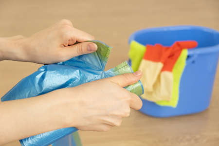 Female hands hold trash bags.の写真素材