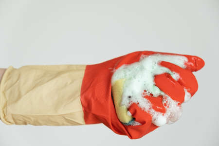  Hands in gloves for cleaning. The sponge with the detergent is foamed in the handの写真素材