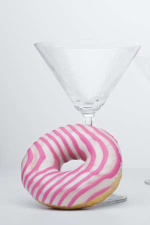  Martini glass and pink donut. Close-up.の写真素材