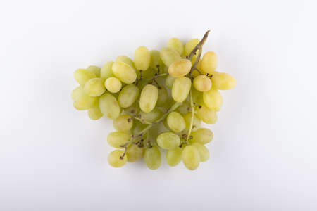 bunch of green grapes close-up on a white backgroundの写真素材