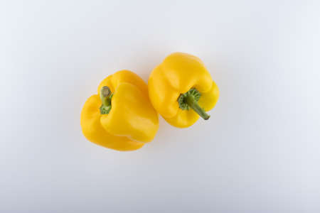 fresh yellow bell peppers close-up on a white backgroundの写真素材