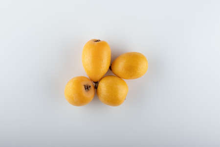 fresh Japanese medlar fruit close up on white backgroundの写真素材