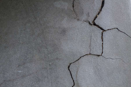 Old concrete wall surface cracks vertically it is helpful for you to use as an illustration of the contentの写真素材
