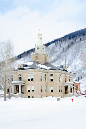 Old town hall in mountains with lots of snowの写真素材