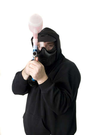 Man with paintball gun in black hoodie and maskの写真素材