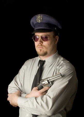 Police Officer with dark glasses and revolver