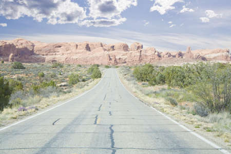 road through arches area mountains and spires in Utah USAの写真素材