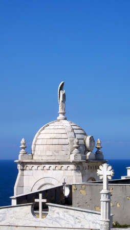 Old catholic church statue overlooking the Atlantic in Luarca Spainの写真素材