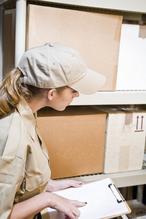 A young worker taking inventory in a warehouse