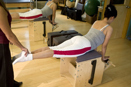Young hispanic woman doing pilates in a gym