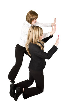 team of business women pushing blank object isolated on whiteの写真素材