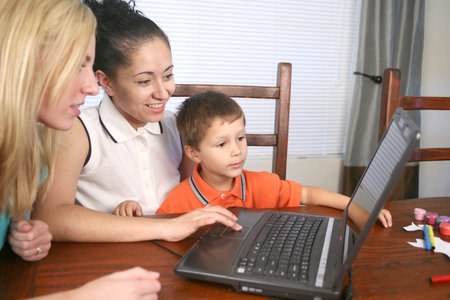 A family sitting at their computer looking on the internet