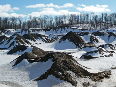 Rural construction pit in winter with treelineの写真素材