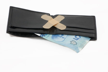 Money in a wallet with bandages.