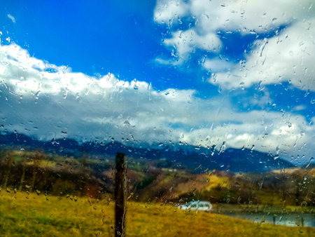 Blurry landscape seen through a wet window