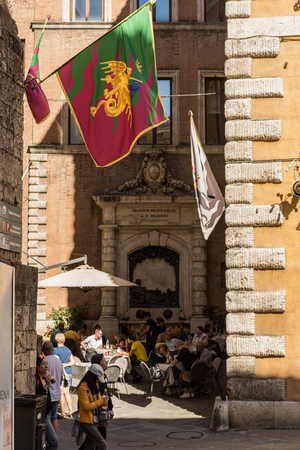 Siena, Italy - September 30 2018: Narrow street in Contrada del Drago, the Dragon historical district of Sienaのeditorial素材