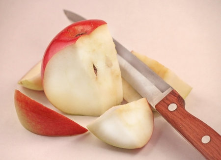 Apple sliced into many parts with a knifeの写真素材