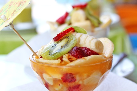 Fruit salad with kiwi, strawberries, bananas, other fruits and yogurtの写真素材