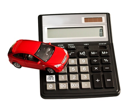 Toy car and calculator. Concept for buying, renting, insurance, fuel, service and repair costsの写真素材
