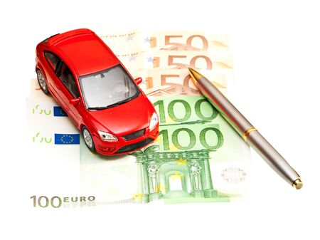 Toy car, pen and money over white  Rent, buy or insurance car conceptの写真素材
