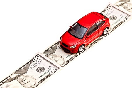 Toy car on the money road, isolated on white  Rent, buy, repair or insurance car conceptの写真素材