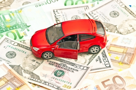 Car and money. Concept for buying, renting, insurance, fuel, service and repair costsの写真素材