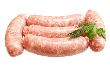 Raw meat sausages with greens isolated on white backgroundの写真素材