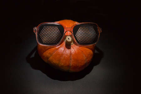 Ripe orange pumpkin on a black backgroundの写真素材