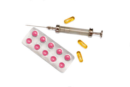 syringe and pills isolated on white backgroundの写真素材