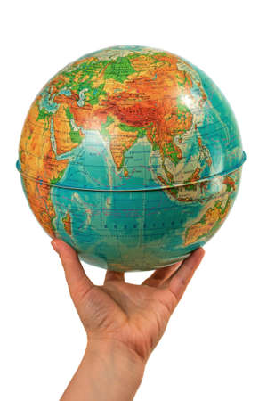 hand holding a globe on which all the names written in Russianの写真素材