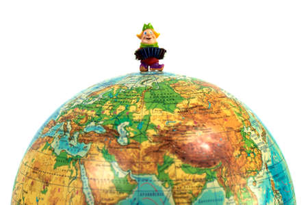 Doll man playing an accordion on a globeの写真素材