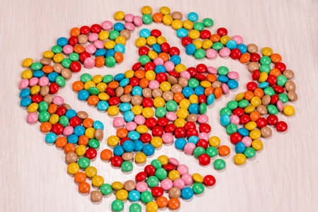 colored round candy scattered in the form of starsの写真素材