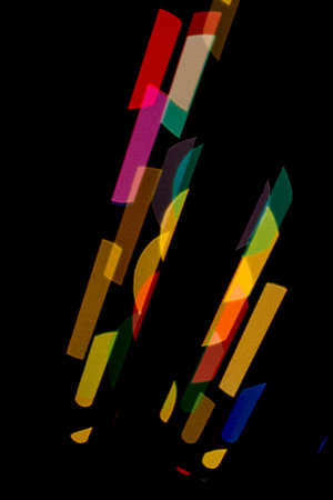 Black background with colored shapes stand upright