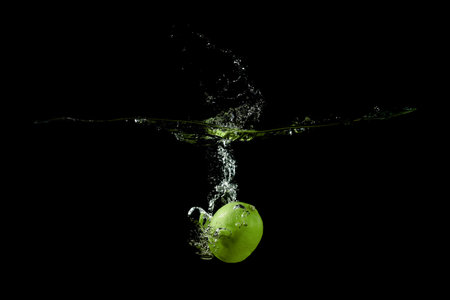 lime fell into the water and raised a lot of splashes on black backgroundの写真素材