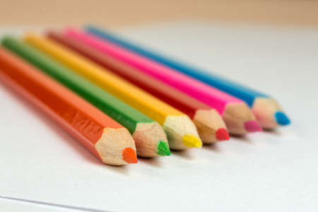 colored pencils to draw lying on a blank sheet of paperの写真素材