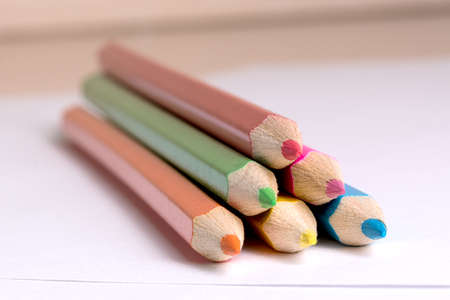 colored pencils to draw lying on a blank sheet of paperの写真素材