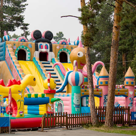 children's amusement park among trees inflatable cityの写真素材