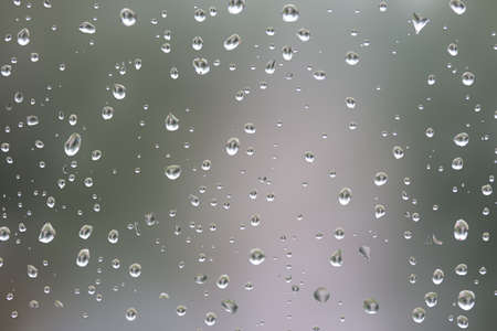 big water drop on the glass a blurred backgroundの写真素材