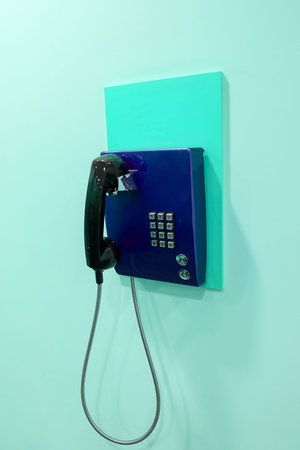 blue phone on a wallの写真素材