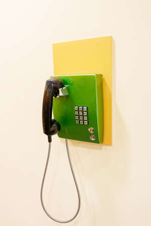 green phone on a beige wallの写真素材